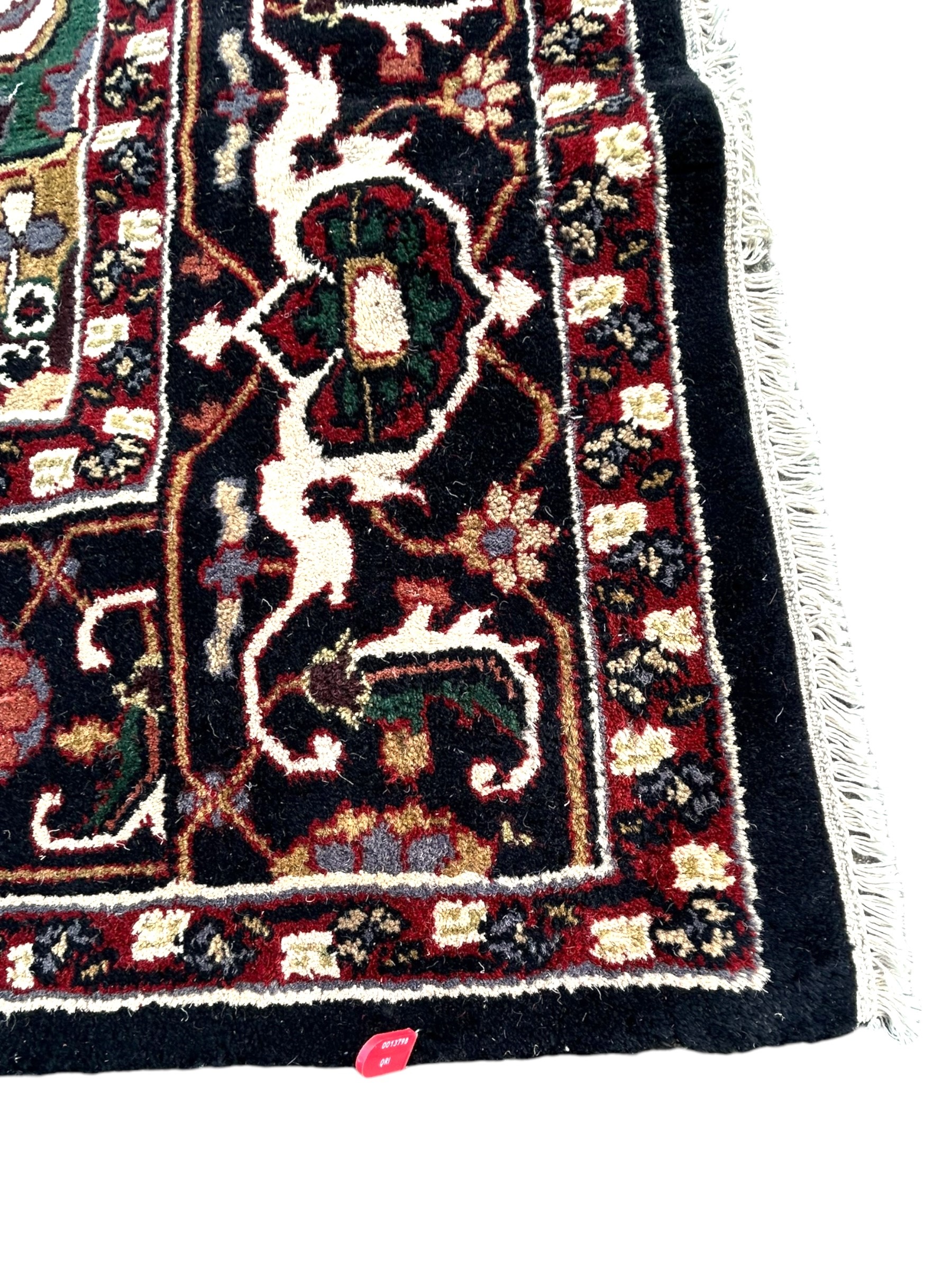 A 20TH CENTURY PERSIAN STYLE HERIZ CARPET Having central floral medallion on red and white ground, - Image 3 of 4