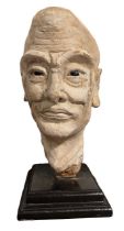 A CHINESE MING PERIOD TERRACOTTA Polychrome painted head of a Luohan with polished stone inset eyes,