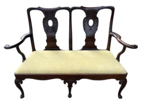 AN 18TH CENTURY IRISH CARVED MAHOGANY DOUBLE CHAIR BACK SETTEE The scrolling back and arms decorated