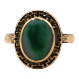 A VINTAGE 14CT YELLOW GOLD AND NEPHRITE RING The central oval cabochon cut nephrite in bezel
