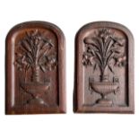 A PAIR OF 19TH CENTURY CARVED OAK ARCH PANELS DECORATED with urns flowers and foliage.