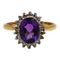 AN 18CT YELLOW GOLD, AMETHYST AND DIAMOND CLUSTER RING The central oval cut amethyst (approx. 8mm