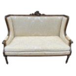 A 19TH CENTURY FRENCH LOUIS XVI DESIGN CARVED GILTWOOD WINGBACK SETTEE The back carved with a
