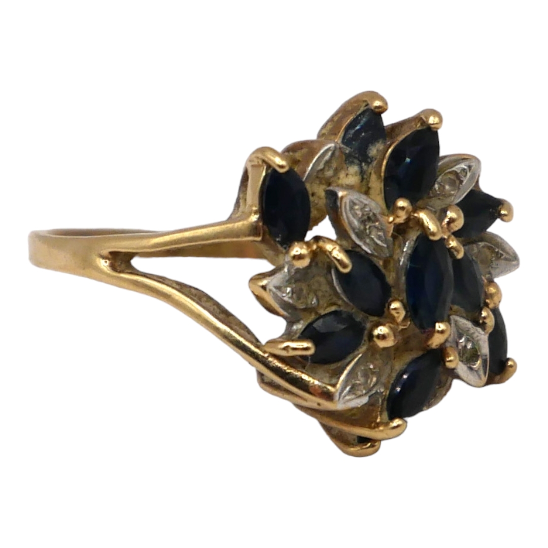 A 9CT GOLD, DIAMOND AND TOPAZ CLUSTER RING Having eleven marquise cut blue topazes (largest - Image 2 of 3
