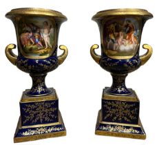 ACKERMANN & FRITZE, A PAIR OF EARLY 20TH ENTURY VIENNA STYLE TWIN HANDLED PORCELAIN URNS Decorated