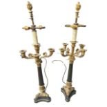 A PAIR OF EMPIRE DESIGN GILT METAL AND BRONZE FOUR BRANCH CANDLEABRAS Supported on reeded columns