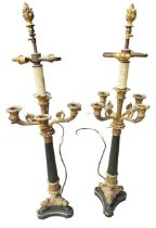 A PAIR OF EMPIRE DESIGN GILT METAL AND BRONZE FOUR BRANCH CANDLEABRAS Supported on reeded columns
