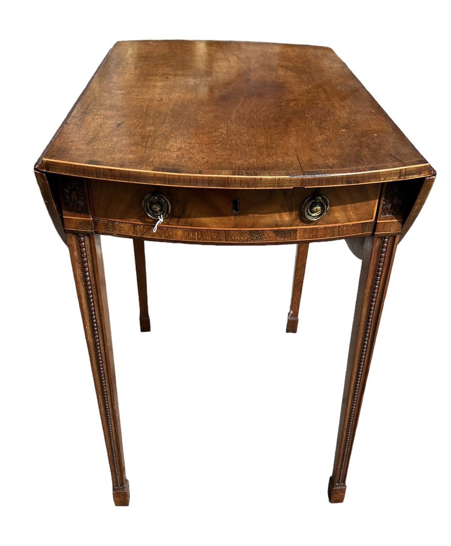 A GEORGE III CARVED MAHOGANY AND INLAID OVAL PEMBROKE TABLE With single drawer raised on square