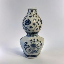 A 19TH CENTURY CHINESE STYLE BLUE AND WHITE DOUBLE GOURD VASE With lotus and vine decoration. (