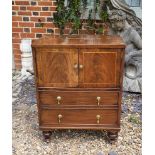 A REGENCY PERIOD WALNUT VENEER COMMODE The string inlay facade with drop handles covers a later