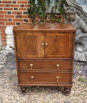 A REGENCY PERIOD WALNUT VENEER COMMODE The string inlay facade with drop handles covers a later