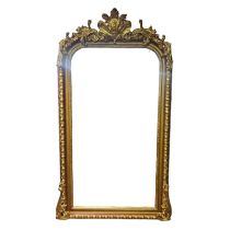 A LARGE 19TH CENTURY STYLE GILT FRAMED MIRROR With organic crest cartouche above a bevelled