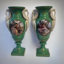 A PAIR OF FRENCH SEVRES STYLE GREEN PORCELAIN URNS In classic amphora form with swan neck handles