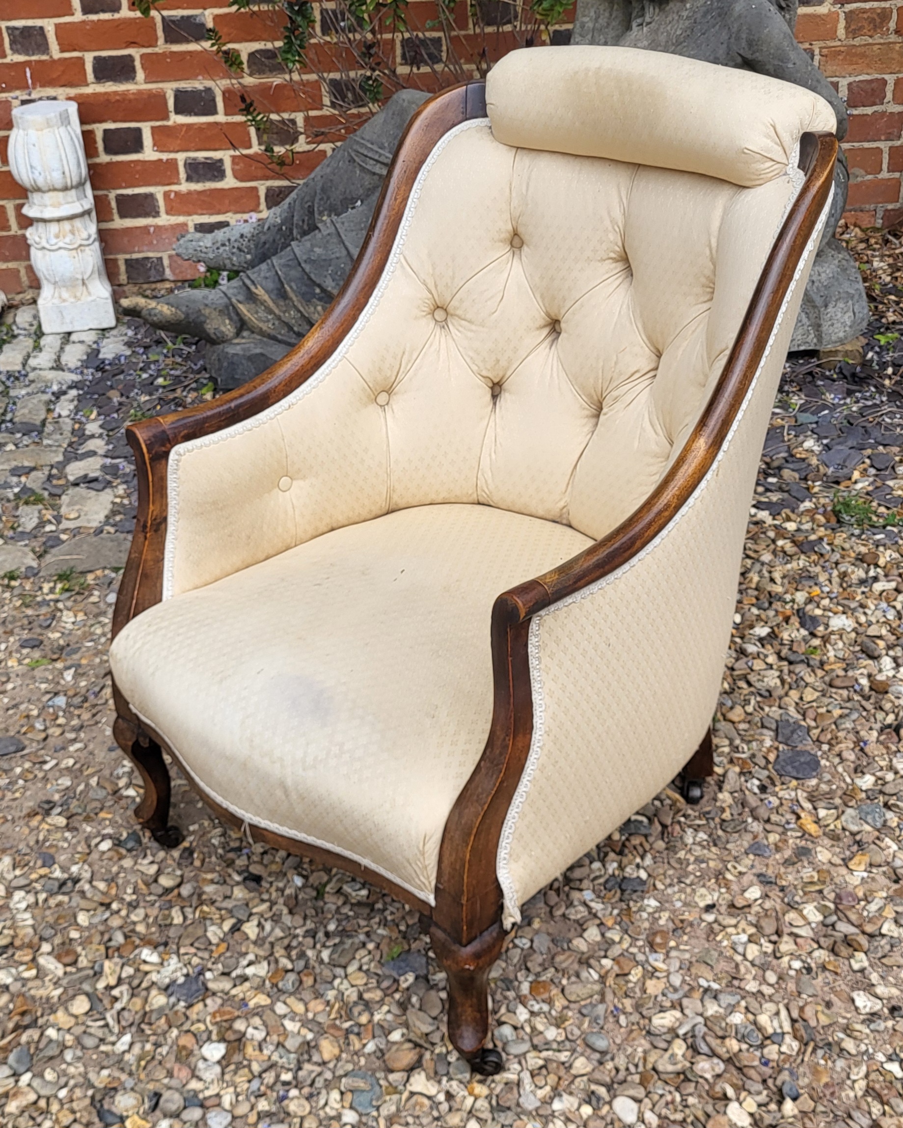 A VICTORIAN MAHOGANY TUB NURSING ARMCHAIR With cushioned headrest and button back upholstery on