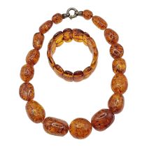 A VINTAGE BALTIC AMBER NECKLACE AND BRACELET Graduated beads with Continental silver clasp, together