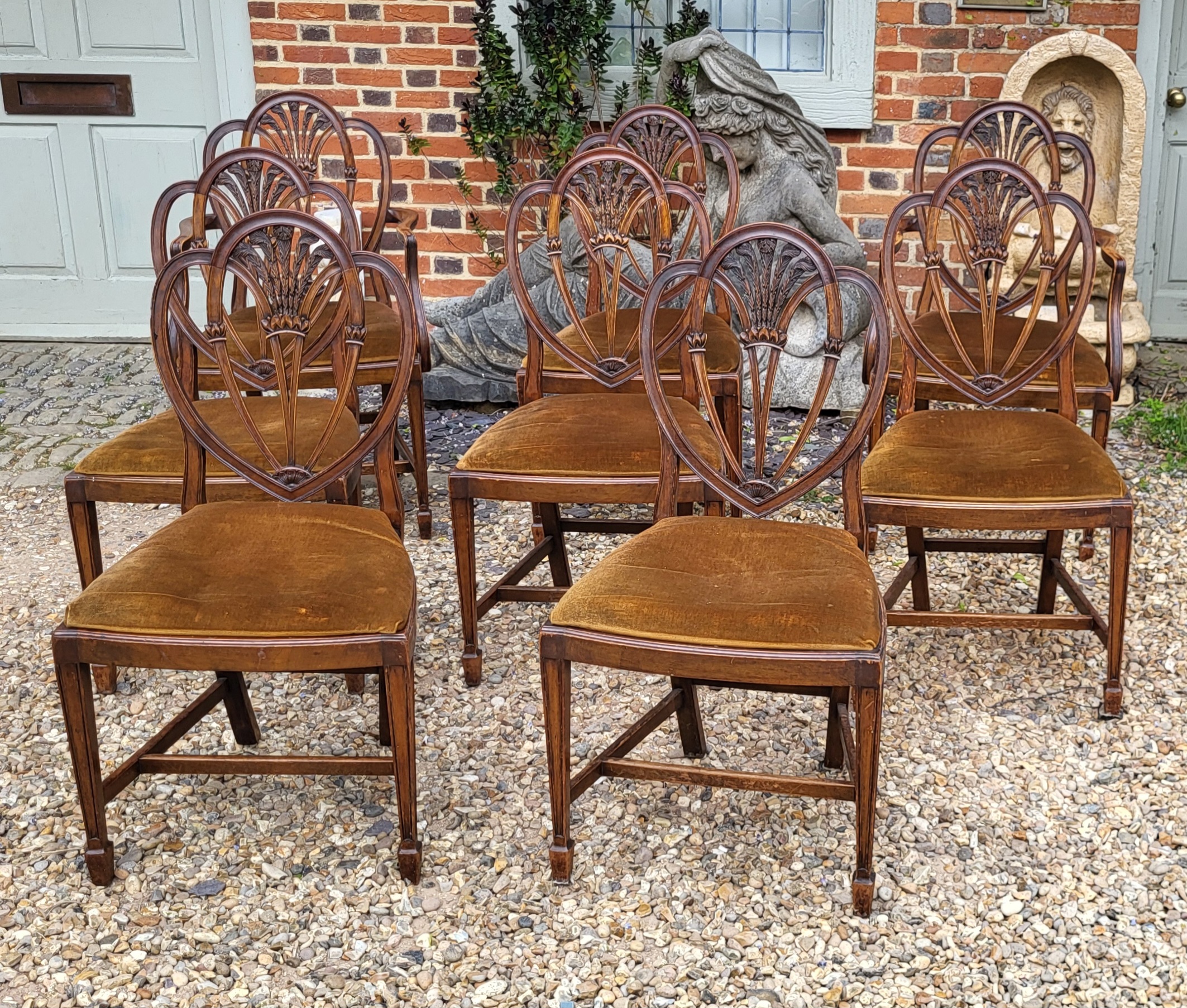 A SET OF EIGHT GEORGIAN HEPPLEWHITE DESIGN MAHOGANY DINING CHAIRS Fan shaped splats with carved
