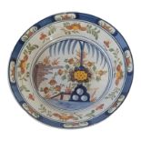 DELFT, A 19TH CENTURY CONTINENTAL TWIN GLAZED EARTHENWARE CHARGER Centrally polychrome painted