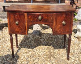 A GEORGIAN MAHOGANY BOW FRONTED SIDE CABINET Of small proportions with three drawers, on ring turned