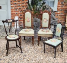 A PAIR OF VICTORIAN MAHOGANY PRIEDIEU CHAIRS With tapestry upholstery on carved Gothic design