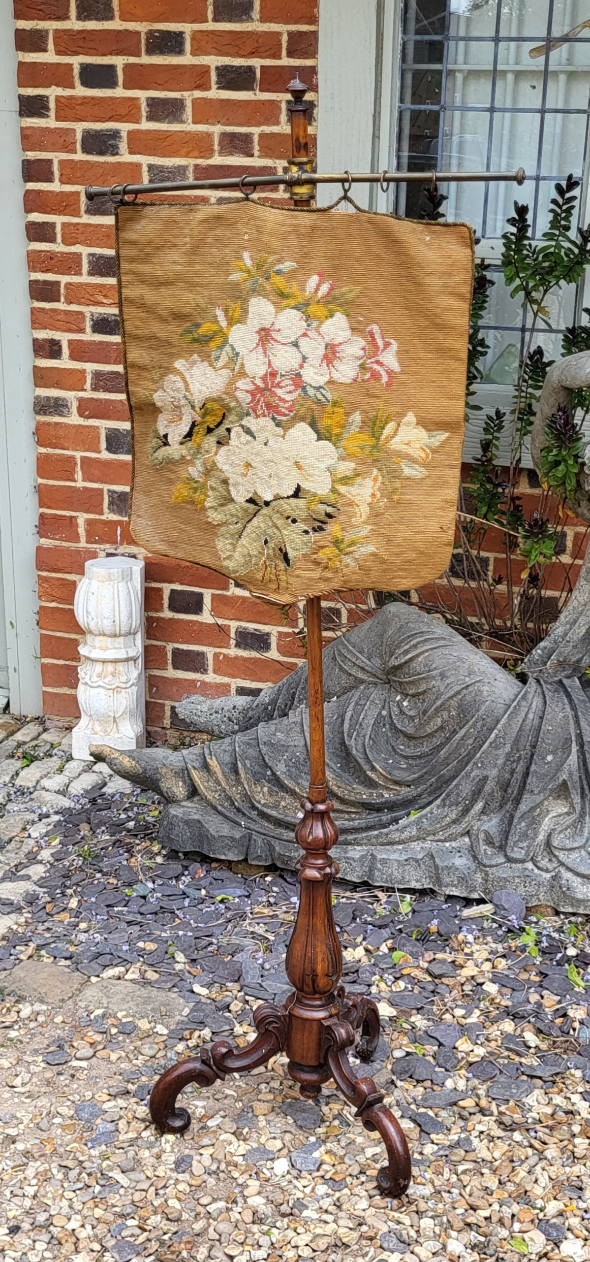 A VICTORIAN WALNUT TAPESTRY FIRE SCREEN Adjustable support on central column, with carved tulip stem