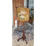 A VICTORIAN WALNUT TAPESTRY FIRE SCREEN Adjustable support on central column, with carved tulip stem