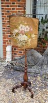 A VICTORIAN WALNUT TAPESTRY FIRE SCREEN Adjustable support on central column, with carved tulip stem