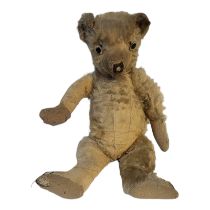AN EARLY 20TH CENTURY PLUSH MOHAIR TEDDY BEAR Having glass eyes, elongated nose and arms. (approx