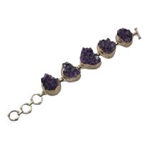 A VINTAGE SILVER AND AMETHYST BRACELET Five amethyst rock clusters in collet silver mount. (approx