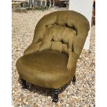 A VICTORIAN NURSING CHAIR Having button back upholstery on turned supports with brass castors. (60cm