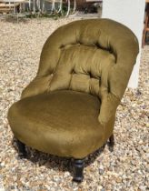 A VICTORIAN NURSING CHAIR Having button back upholstery on turned supports with brass castors. (60cm