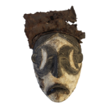 A 20TH CENTURY AFRICAN TRIBAL CARVED WOOD AND FABRIC 'IGBO' MASK Sad features with black crescent