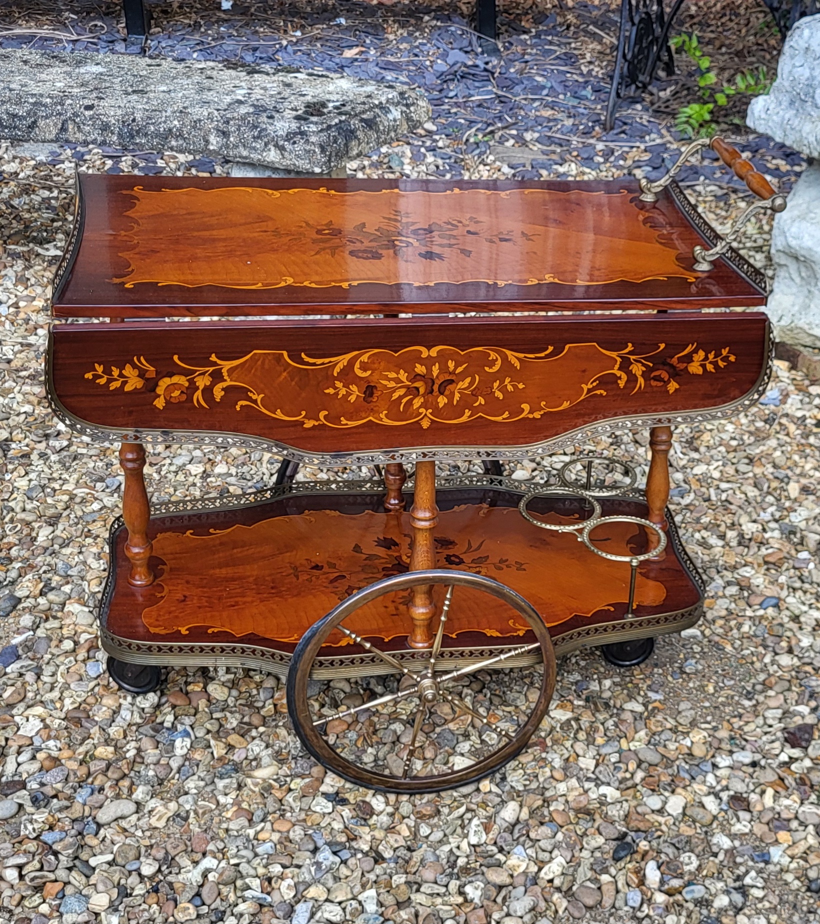 AN ITALIAN MID CENTURY MAHOGANY AND BRASS INLAID DRINKS TROLLEY Having pierced brass gallery,