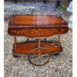 AN ITALIAN MID CENTURY MAHOGANY AND BRASS INLAID DRINKS TROLLEY Having pierced brass gallery,