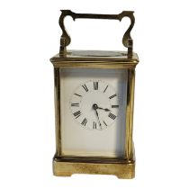 AN EARLY 20TH CENTURY GILT BRASS CORNICHE CASED CARRIAGE CLOCK The eight day movement, white