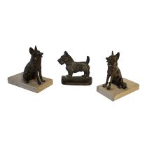 A PAIR OF ART DECO PERIOD CONTINENTAL SPELTER BOOKENDS MODELLED AS SEATED DOGS Raised on marble