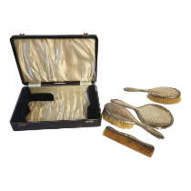 AN EARLY 20TH CENTURY SILVER BRUSH AND COMB SET Comprising a hand mirror, two hairbrushes and