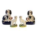 A PAIR OF VICTORIAN STAFFORDSHIRE PEARLWARE MODELS OF DALMATIANS With painted features, gilt collars