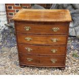 A 19TH CENTURY MAHOGANY BOW- FRONTED COMMODE The hinged lid and brass handle escutcheons,