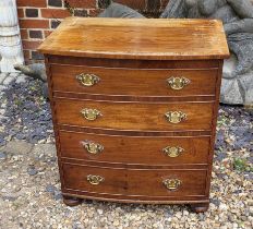 A 19TH CENTURY MAHOGANY BOW- FRONTED COMMODE The hinged lid and brass handle escutcheons,