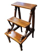 A 20TH CENTURY VICTORIAN STYLE MAHOGANY GRADUATED THREE SECTION LIBRARY STEPS Supported by two