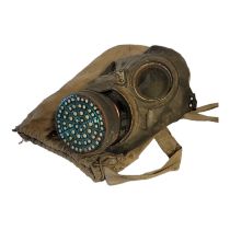 A WWII BRITISH MILITARY RUBBER AND GLASS PROTECTIVE GAS MASK In original carrying cloth case.