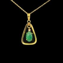 A VINTAGE 14CT GOLD AND JADE PENDANT NECKLACE An oval cut stone in a triangular mount, on a fine