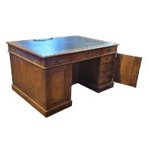 A VICTORIAN OAK PARTNER'S DESK With green tooled leather writing surface above arrangement of