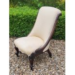 A VICTORIAN ROSEWOOD LOW CHAIR Having cream upholstery with scrolled back and carved cabriole legs