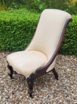 A VICTORIAN ROSEWOOD LOW CHAIR Having cream upholstery with scrolled back and carved cabriole legs