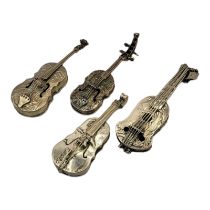 A COLLECTION OF FOUR EARLY 20TH CENTURY SILVER NOVELTY CELLO Having embossed figural decoration,