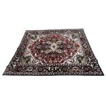 A 20TH CENTURY PERSIAN STYLE HERIZ CARPET Having central floral medallion on red and white ground,