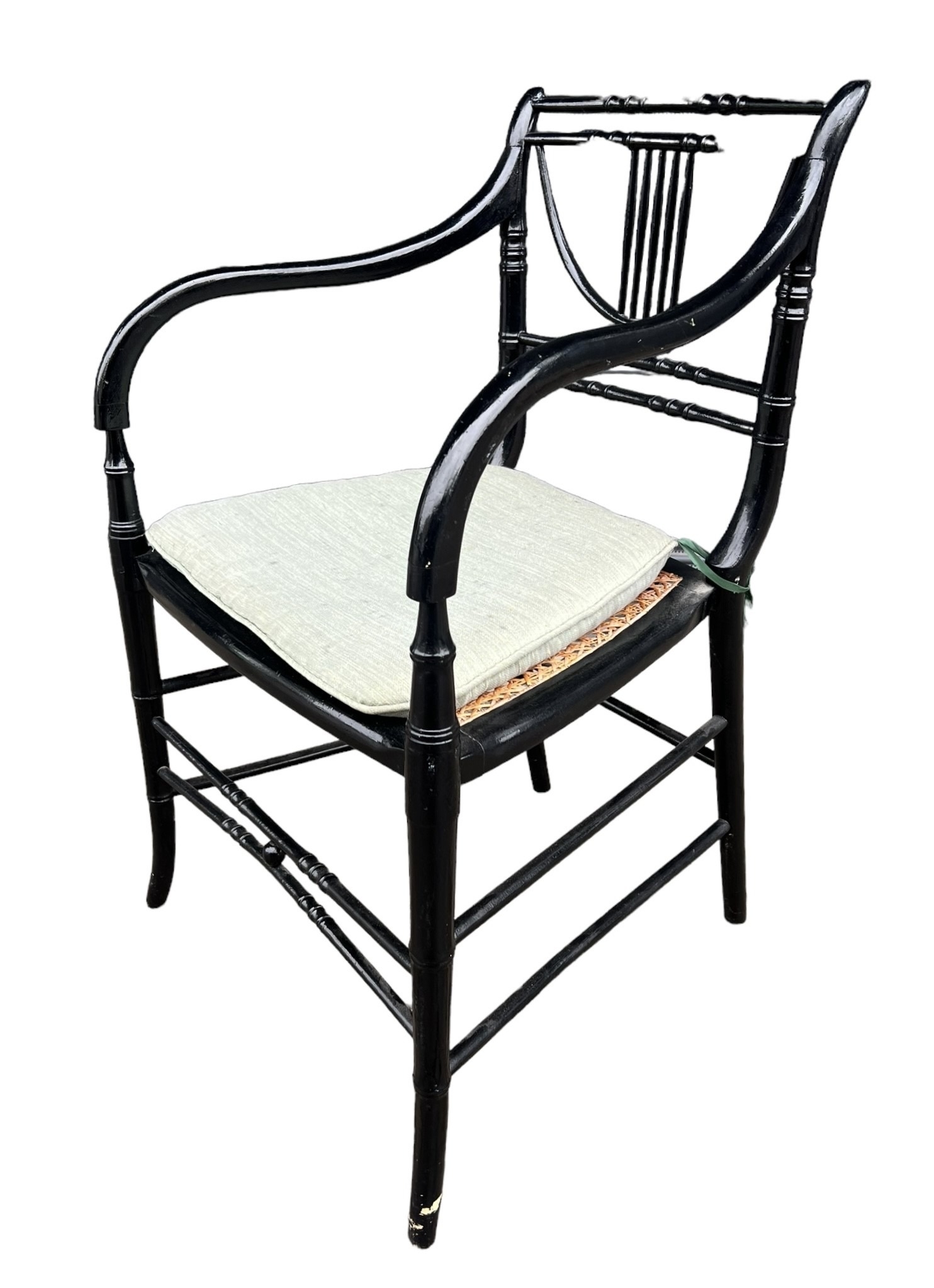 A 19TH CENTURY REGENCY FAUX BAMBOO PAINTED ARMCHAIR With cane seat and loose cushion.
