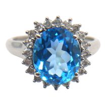 A 9CT WHITE GOLD, BLUE TOPAZ AND DIAMOND RING Having central oval cut blue topaz (approx. 12mm x