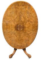 A VICTORIAN FIGURED WALNUT AND INLAID OVAL LOO TABLE The tilt top supported on a carved pedestal